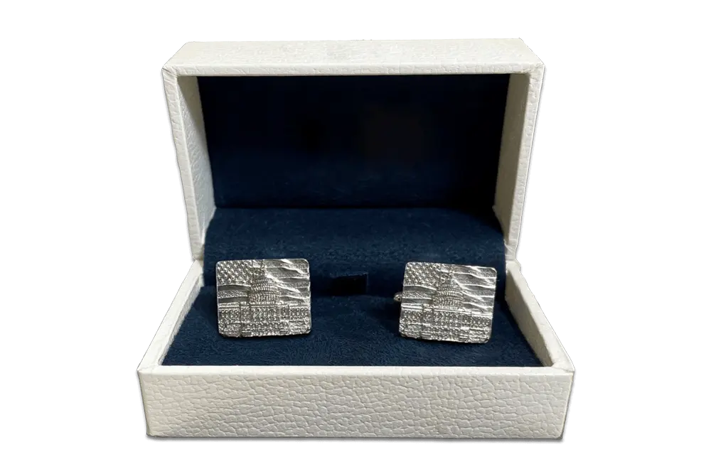 Completed sterling silver cufflinks displayed in a decorative cufflink box.  