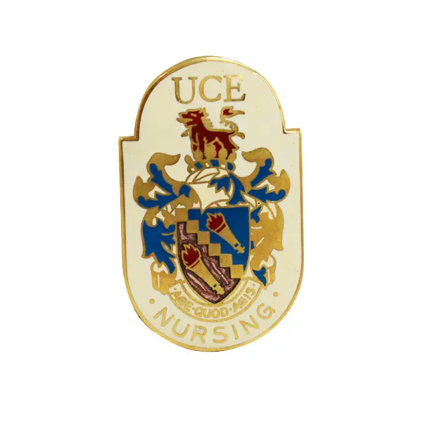 Die stamped, gold plated Nursing badge with enamel inlay, featuring the University of Central England crest.