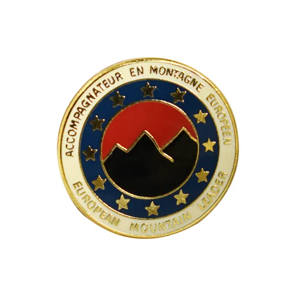 Die stamped, gold-plated badge featuring the European Mountain leader crest with enamel inlay.