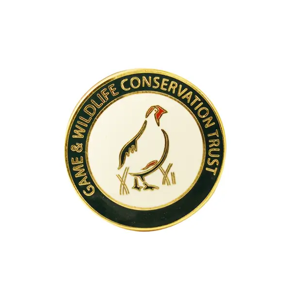 Die stamped, gold plated Game & Wildlife Conservation Trust Badge.