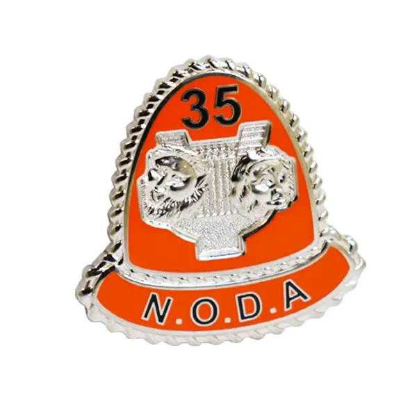 Die stamped, silver plated NODA badge with Orange enamel inlay.