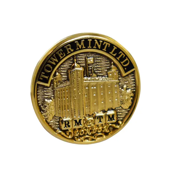 Die stamped, gold-plated Tower Mint logo badge with enamel inlay.