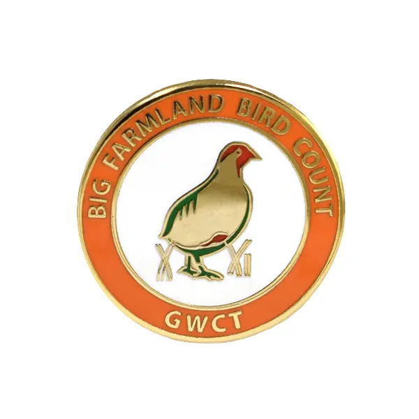 Die stamped, gold plated GWCT Big Farmland Bird Count Badge with enamel inlay.