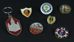 Selection of badges, coins and key-rings.