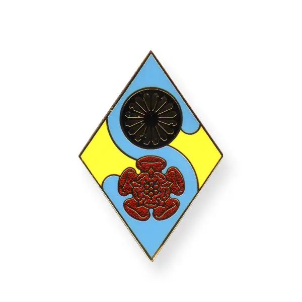 Die stamped, gold plated South Lancashire girl guide logo badge with multi tonal enamel inlay.