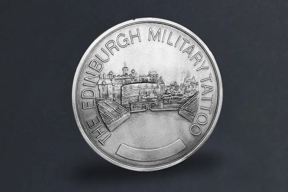 Die stamped Edinburgh Military Tattoo coin with powder coated finish.