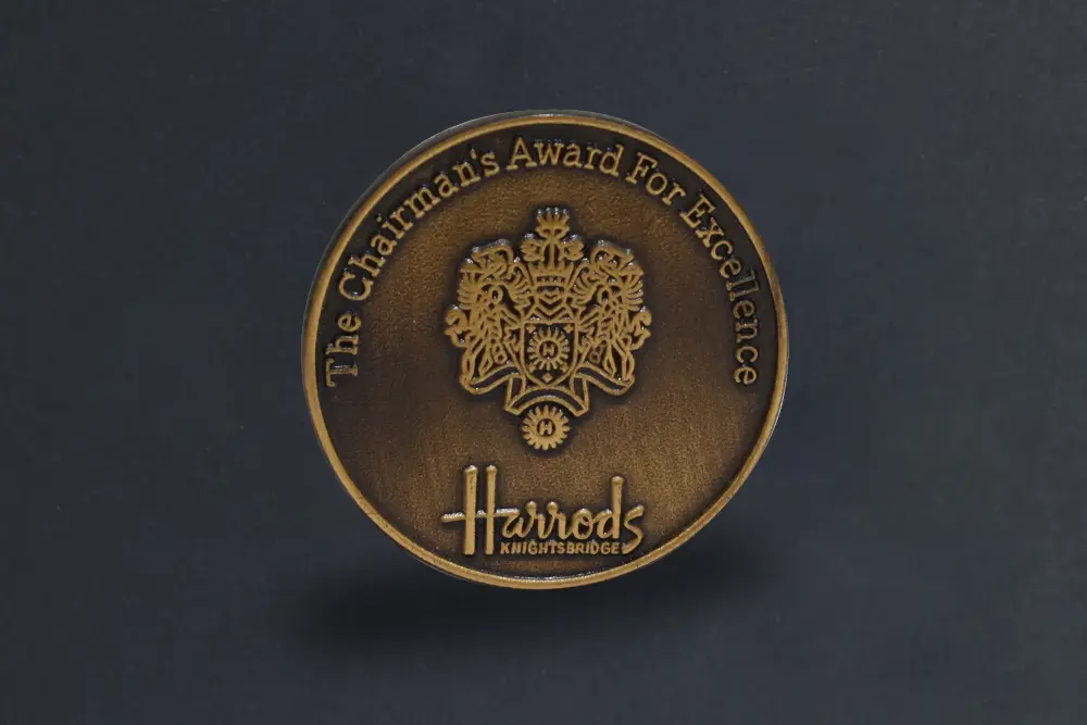 Die stamped, antique bronze Harrods medal