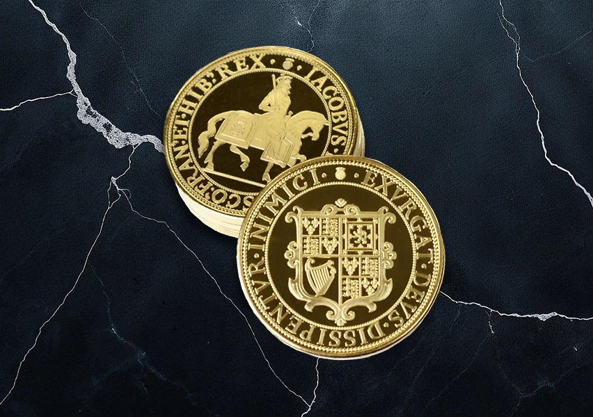 A top-down view of meticulously crafted, gold-plated replica coins showcasing their intricate details.