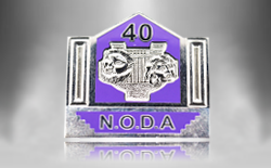 Die stamped, palladium plated National Operatic and Drama Association badge.