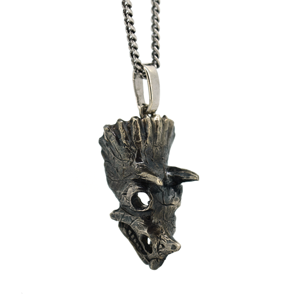 Die cast triceratops skull pendant.