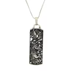 Die stamped, rounded rectangular pendant featuring wild horses.