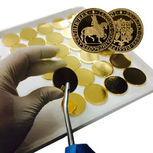 Cleaning off coin for stamping.