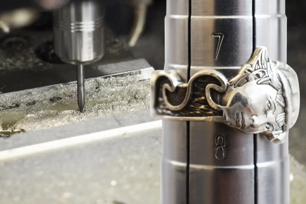 The Britannia Ring being milled on the CNC machine and formed to size on a ring sizing mandrel.